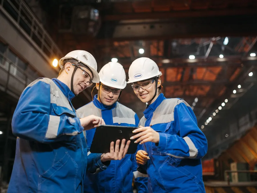 Equipe técnica analisando um projeto no chão de fábrica